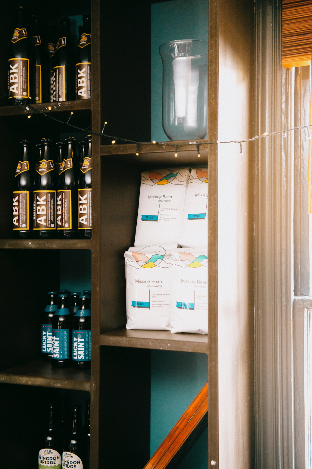 Missing Bean wholesale coffee bean bags stocked on shelves nest to artisan larger bottles