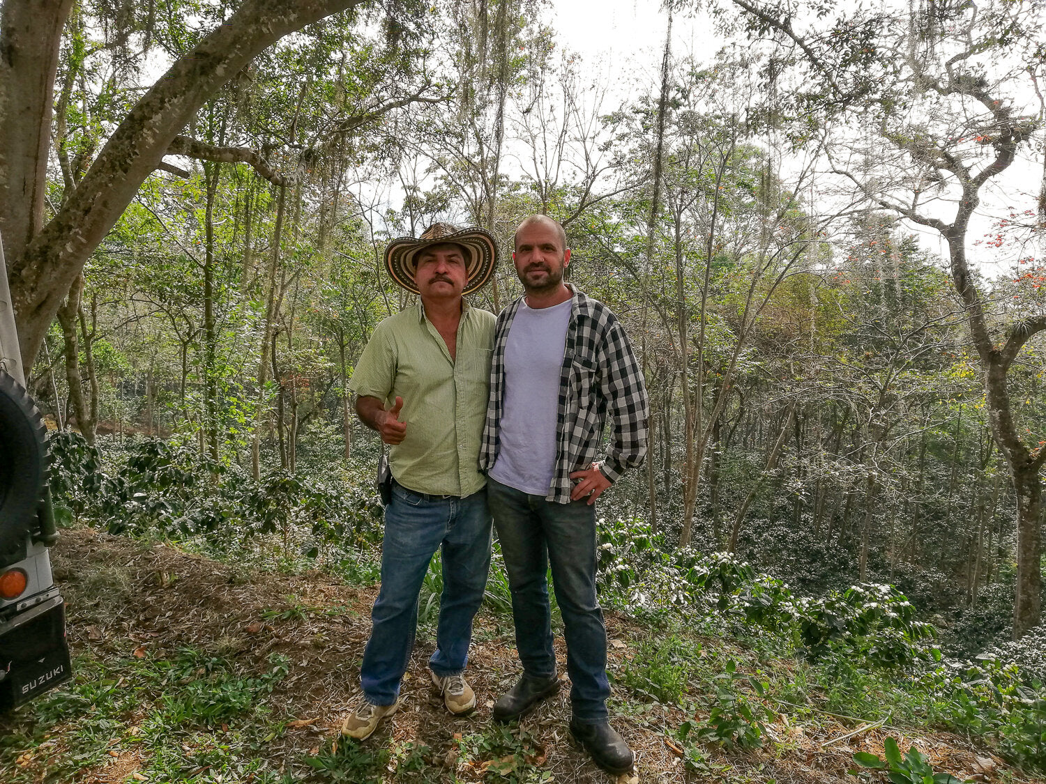 Missing Bean’s founder, Ori, poses with owner of El Calapo coffee farm, Santiago Salazar Junior in the lush foothills of the Andes.
