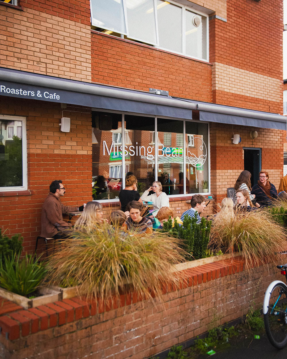 Missing Bean customers sitting outdoors at their East Oxford cafe and coffee bean roastery