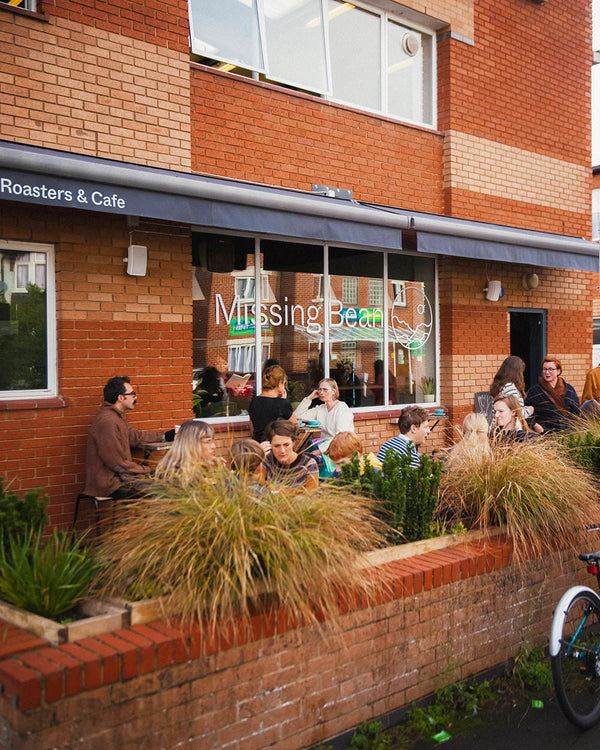 Missing Bean customers sitting outdoors at their East Oxford cafe and coffee bean roastery
