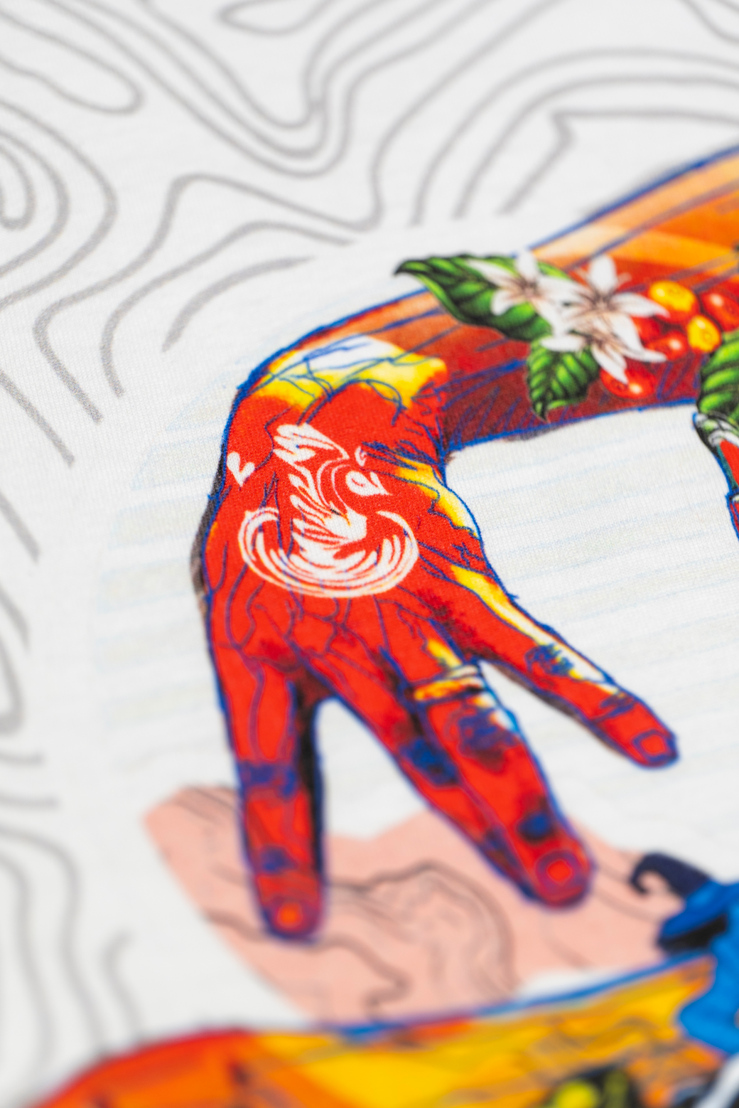 Close up of one of the hands on the back print of the white Missing bean X Brian Gray T-Shirt, the back print depicts two hands spelling out MB which are detailed with a range of clever, original, sketches to signify the journey of a coffee bean.